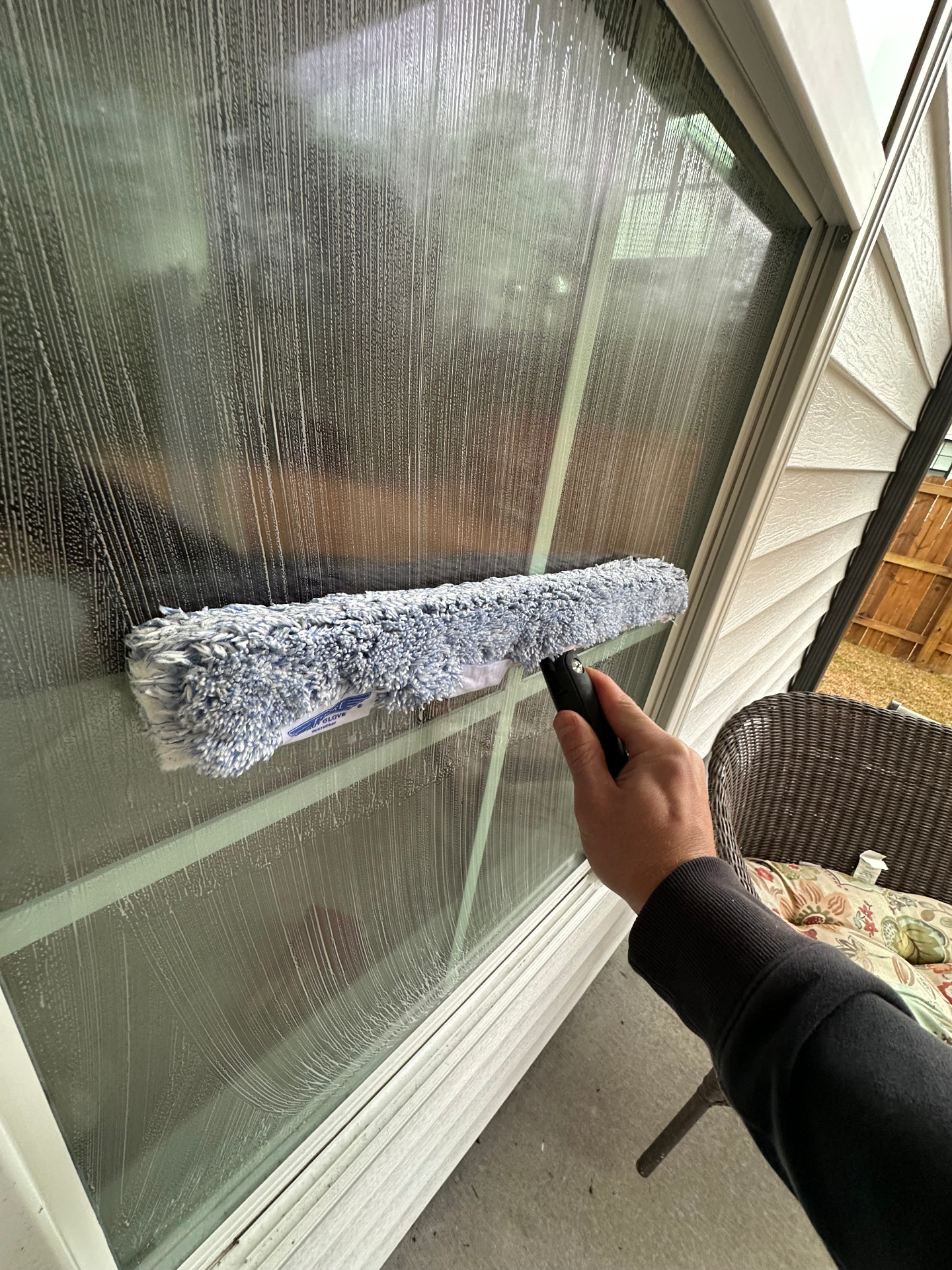 Professional squeegee cleaning a window